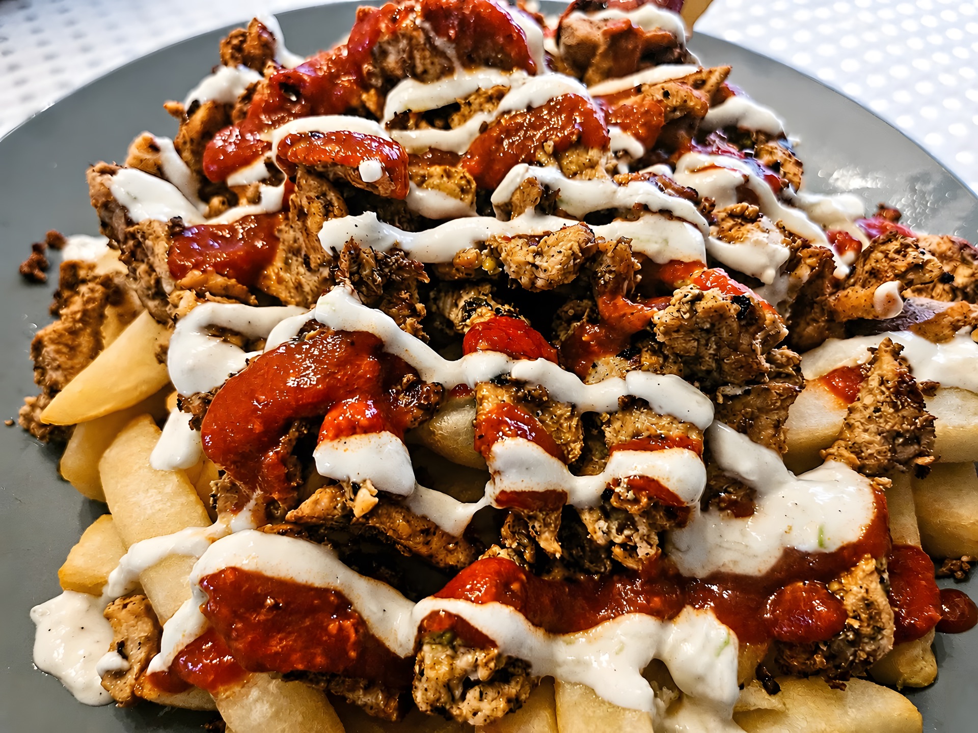 Grilled meat on chips with sauces